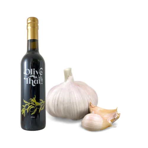 Garlic Infused Extra Virgin Olive Oil bottle with fresh garlic by Olive That